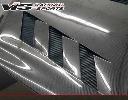 2009-2012 Infiniti G37 4Dr Ams Style Carbon Fiber Hood. VIS Carbon Fiber Hoods and Trunks are made from 100% ISO-certified, Grade-A carbon fiber material.  All VIS Carbon Fiber Hoods and Trunks are manufactured using a two-part construction design.  The top layer is composed of carbon fiber material bonded to the hood surface with high-grade epoxy resin, andfinished with an ultra-clear (Poly Shield), UV-protective polyurethane coating for a high gloss finish.  A one-piece, smooth underside shell is fused to the top layer enhancing the product’s structural integrity.  The edges are smoothed by hands to insure good quality finish all around. In 2014, we further improved on this manufacturing process by introducing the Vacuum Infusion Process (V.I.P.), which utilizes a single-mold vacuum to produce parts that are 10-20% lighter than before while improving durability. We are transitioning our full spectrum of carbon parts to use the VIP process so that our customers can enjoy these improved products without incurring a huge cost increase.
All VIS Carbon Fiber Hoods and Trunks come with a VIS badge of authenticity. Please be sure to look for the badge when purchasing. Due to the unknown nature of the intended uses of these products, hood pins are required. These products are intended for off-road use only, unless your local and state laws state otherwise.