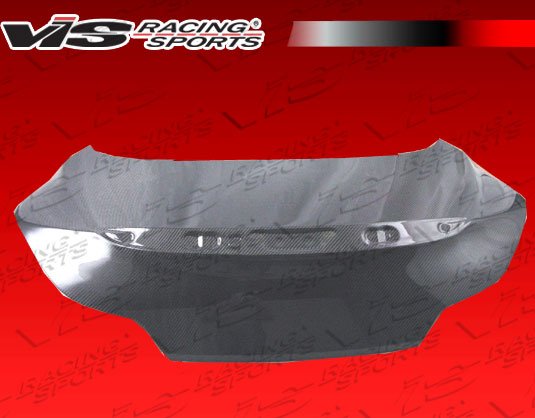 2008-2013 Infiniti G37 2Dr Oem Style Carbon Fiber Trunk. VIS Carbon Fiber Trunks are made from 100% ISO-certified, Grade-A carbon fiber material. All VIS Carbon Fiber Trunks are manufactured using a two-part construction design. The top layer is composed of carbon fiber material bonded to the trunk surface with high-grade epoxy resin, andfinished with an ultra-clear (Poly Shield), UV-protective polyurethane coating for a high gloss finish. A one-piece, smooth underside shell is fused to the top layer enhancing the product’s structural integrity. The edges are smoothed by hands to insure good quality finish all around. In 2014, we further improved on this manufacturing process by introducing the Vacuum Infusion Process (V.I.P.), which utilizes a single-mold vacuum to produce parts that are 10-20% lighter than before while improving durability. We are transitioning our full spectrum of carbon parts to use the VIP process so that our customers can enjoy these improved products without incurring a huge cost increase.
All VIS Carbon Fiber Hoods and Trunks come with a VIS badge of authenticity. Please be sure to look for the badge when purchasing. Due to the unknown nature of the intended uses of these products, hood pins are required. These products are intended for off-road use only, unless your local and state laws state otherwise.