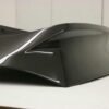 2003-2008 Nissan 350Z Carbon Fiber AMS Tunnel Hatch. VIS Carbon Fiber Trunks are made from 100% ISO-certified, Grade-A carbon fiber material. All VIS Carbon Fiber Trunks are manufactured using a two-part construction design. The top layer is composed of carbon fiber material bonded to the trunk surface with high-grade epoxy resin, andfinished with an ultra-clear (Poly Shield), UV-protective polyurethane coating for a high gloss finish. A one-piece, smooth underside shell is fused to the top layer enhancing the product’s structural integrity. The edges are smoothed by hands to insure good quality finish all around. In 2014, we further improved on this manufacturing process by introducing the Vacuum Infusion Process (V.I.P.), which utilizes a single-mold vacuum to produce parts that are 10-20% lighter than before while improving durability. We are transitioning our full spectrum of carbon parts to use the VIP process so that our customers can enjoy these improved products without incurring a huge cost increase.
All VIS Carbon Fiber Hoods and Trunks come with a VIS badge of authenticity. Please be sure to look for the badge when purchasing. Due to the unknown nature of the intended uses of these products, hood pins are required. These products are intended for off-road use only, unless your local and state laws state otherwise.