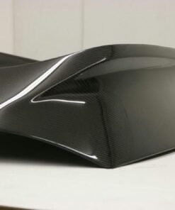 2003-2008 Nissan 350Z Carbon Fiber AMS Tunnel Hatch. VIS Carbon Fiber Trunks are made from 100% ISO-certified, Grade-A carbon fiber material.  All VIS Carbon Fiber Trunks are manufactured using a two-part construction design.  The top layer is composed of carbon fiber material bonded to the trunk surface with high-grade epoxy resin, andfinished with an ultra-clear (Poly Shield), UV-protective polyurethane coating for a high gloss finish.  A one-piece, smooth underside shell is fused to the top layer enhancing the product’s structural integrity.  The edges are smoothed by hands to insure good quality finish all around. In 2014, we further improved on this manufacturing process by introducing the Vacuum Infusion Process (V.I.P.), which utilizes a single-mold vacuum to produce parts that are 10-20% lighter than before while improving durability. We are transitioning our full spectrum of carbon parts to use the VIP process so that our customers can enjoy these improved products without incurring a huge cost increase.
All VIS Carbon Fiber Hoods and Trunks come with a VIS badge of authenticity. Please be sure to look for the badge when purchasing. Due to the unknown nature of the intended uses of these products, hood pins are required. These products are intended for off-road use only, unless your local and state laws state otherwise.