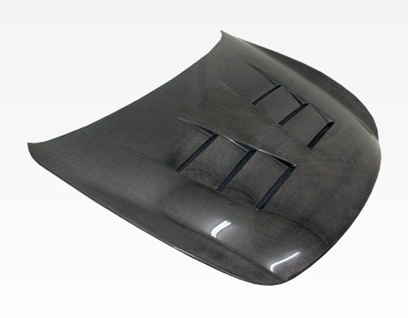 2008-2013 Infiniti G37 2Dr Terminator Carbon Fiber Hood. VIS Carbon Fiber Hoods and Trunks are made from 100% ISO-certified, Grade-A carbon fiber material. All VIS Carbon Fiber Hoods and Trunks are manufactured using a two-part construction design. The top layer is composed of carbon fiber material bonded to the hood surface with high-grade epoxy resin, andfinished with an ultra-clear (Poly Shield), UV-protective polyurethane coating for a high gloss finish. A one-piece, smooth underside shell is fused to the top layer enhancing the product’s structural integrity. The edges are smoothed by hands to insure good quality finish all around. In 2014, we further improved on this manufacturing process by introducing the Vacuum Infusion Process (V.I.P.), which utilizes a single-mold vacuum to produce parts that are 10-20% lighter than before while improving durability. We are transitioning our full spectrum of carbon parts to use the VIP process so that our customers can enjoy these improved products without incurring a huge cost increase.
All VIS Carbon Fiber Hoods and Trunks come with a VIS badge of authenticity. Please be sure to look for the badge when purchasing. Due to the unknown nature of the intended uses of these products, hood pins are required. These products are intended for off-road use only, unless your local and state laws state otherwise.